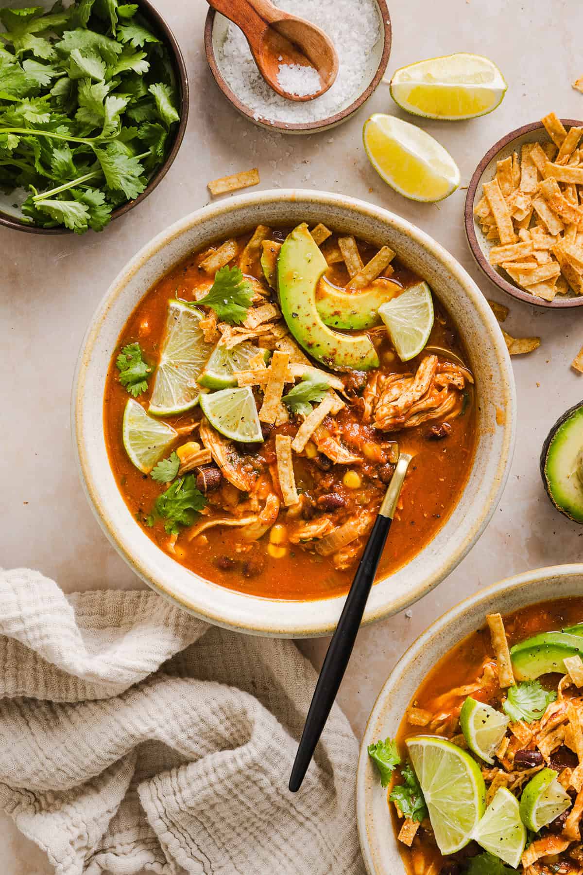 This Easy Chicken Tortilla Soup makes the perfect weeknight meal that can easily be made right in your instant pot, slow cooker or on the stove! Packed with tender shredded chicken, veggies, beans and all the toppings for a delicious, flavor-packed meal!