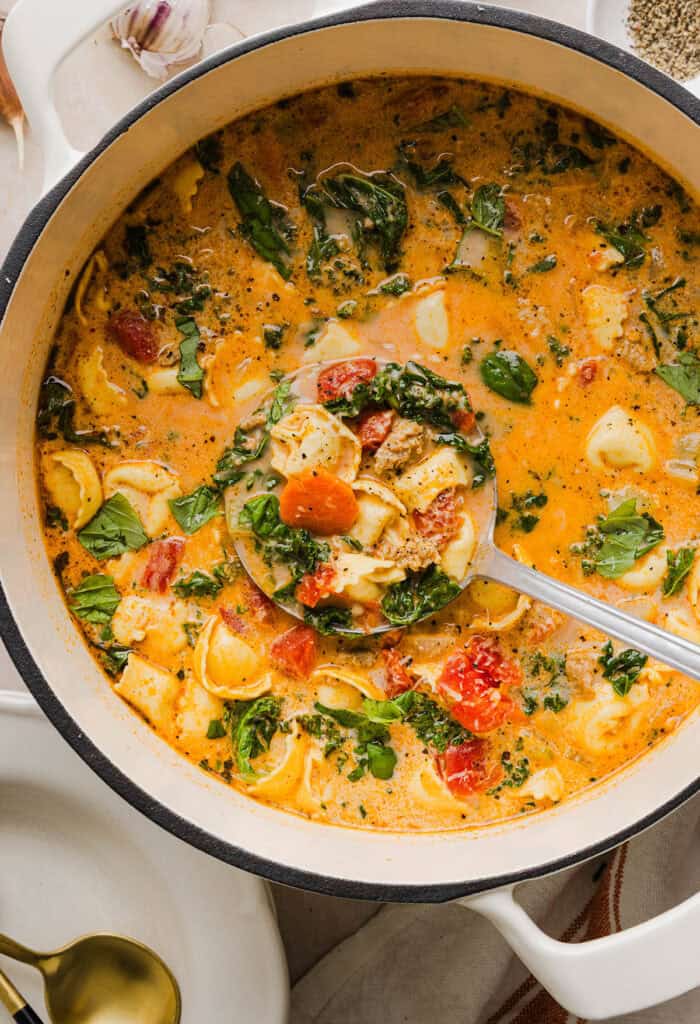 This Creamy Tortellini Soup recipe is cozy, comforting and made with tender cheese tortellini, fresh veggies, herbs and a rich creamy broth. The perfect one pot meal that is both flavorful and satisfying!