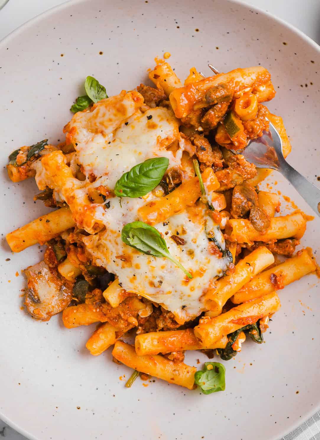 Comforting and delicious Healthy Baked Ziti packed with veggies, flavorful turkey sausage and makes the perfect weeknight meal the whole family will love!  Leftovers guaranteed!