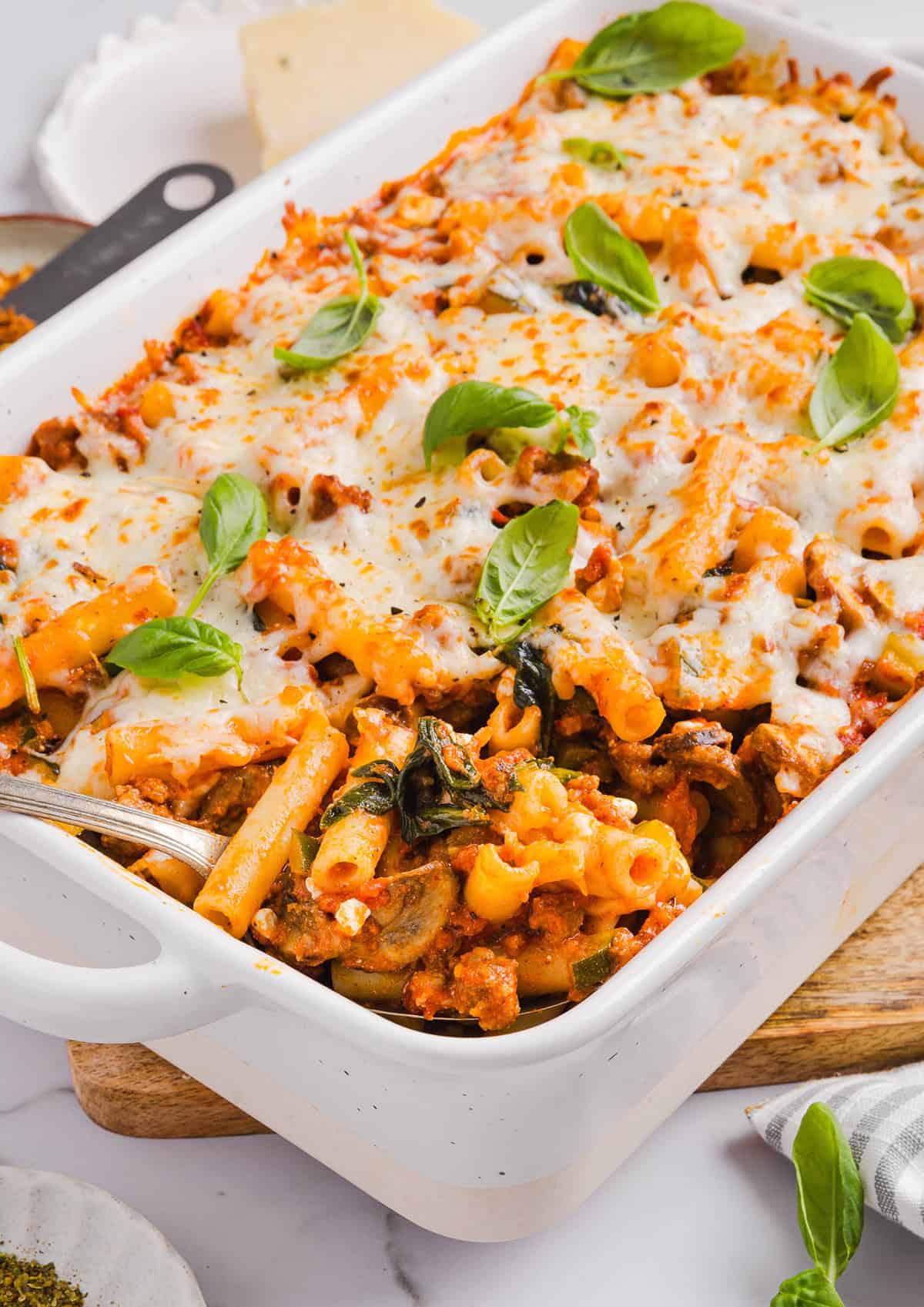 This comforting and delicious Healthy Baked Ziti recipe is packed with fresh veggies, flavorful turkey sausage and makes the perfect weeknight meal the whole family will love!  Leftovers are guaranteed!