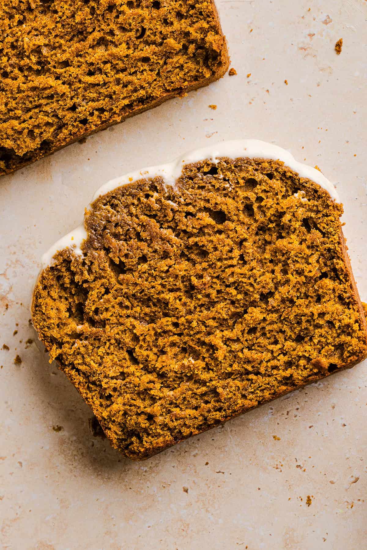 The BEST Healthy Pumpkin Bread that is moist, loaded with pumpkin flavor and made without any butter or refined sugar!  Topped with a delicious maple cream cheese glaze for the perfect fall treat this season!