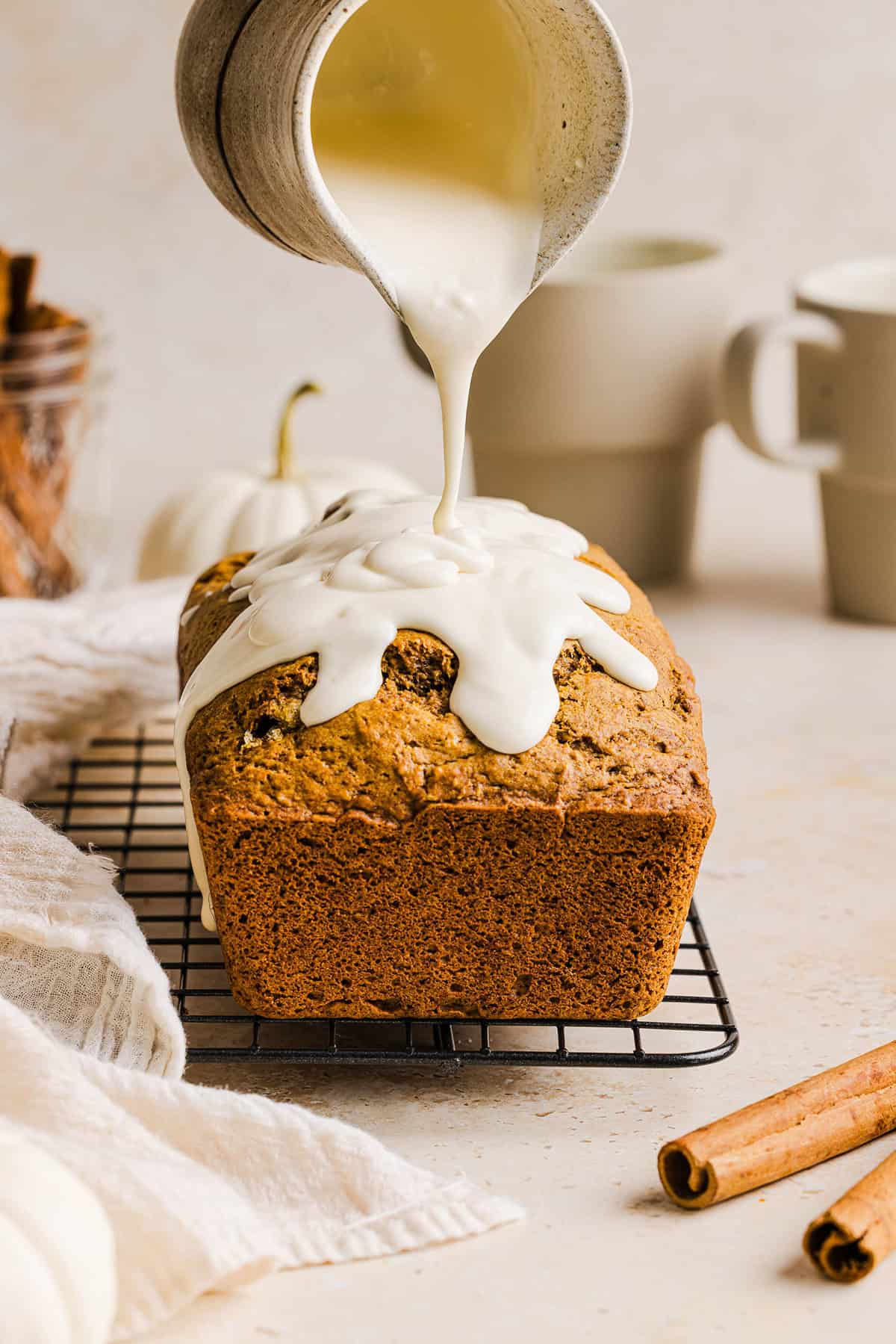 The BEST Healthy Pumpkin Bread that is moist, loaded with pumpkin flavor and made without any butter or refined sugar!  Topped with a delicious maple cream cheese glaze for the perfect fall treat this season!