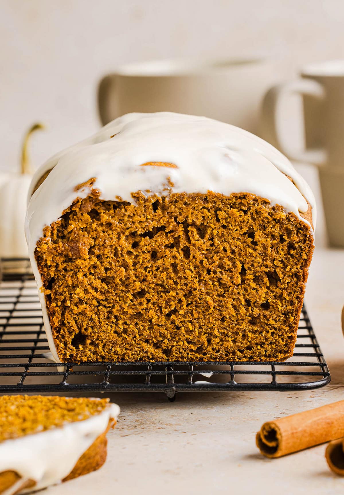 The BEST Healthy Pumpkin Bread that is moist, loaded with pumpkin flavor and made without any butter or refined sugar!  Topped with a delicious maple cream cheese glaze for the perfect fall treat this season!