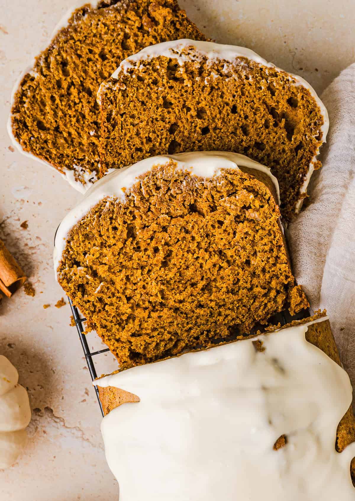 The BEST Healthy Pumpkin Bread that is moist, loaded with pumpkin flavor and made without any butter or refined sugar!  Topped with a delicious maple cream cheese glaze for the perfect fall treat this season!