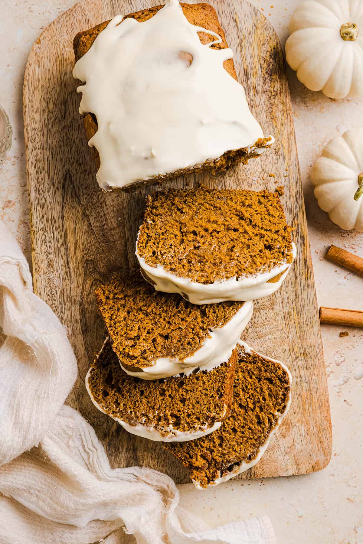The BEST Healthy Pumpkin Bread that is moist, loaded with pumpkin flavor and made without any butter or refined sugar!  Topped with a delicious maple cream cheese glaze for the perfect fall treat this season!