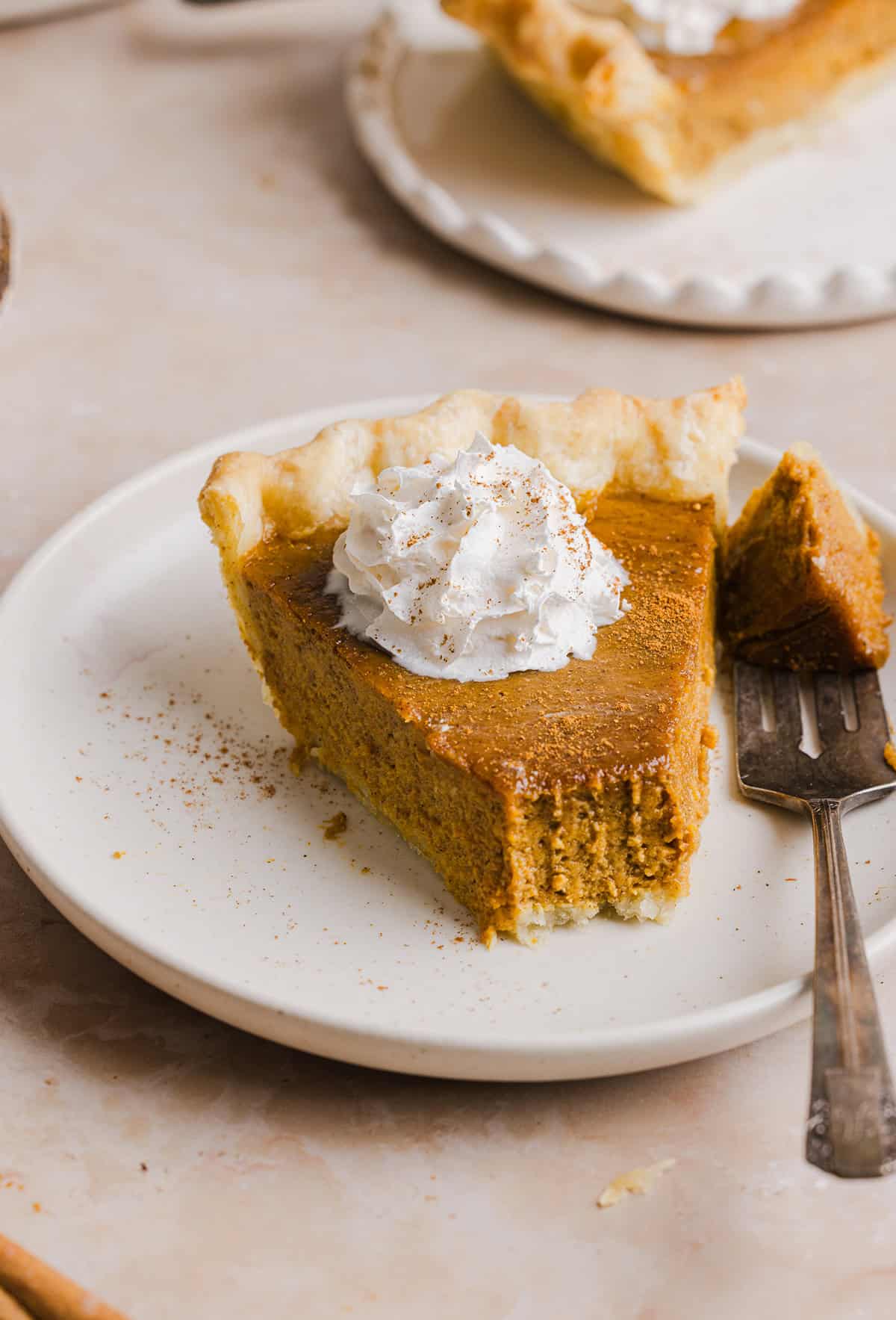 This creamy and delicious Healthy Pumpkin Pie makes the perfect holiday dessert! So easy to make, naturally sweetened with maple syrup and tastes great topped with whipped cream or vanilla ice cream!